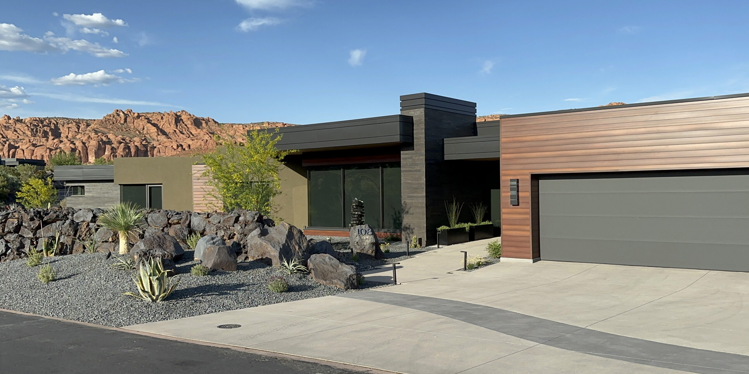 Wood patterned longboard and the angular lines of the sconces, fascias, and chimney caps on this home in the reserve show how our metal work in Ivins dramatically compliments the landscape.