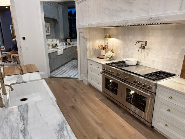 Metallic thresholds separate the kitchen from the pantry at the KH Traveler entry in the 2024 St. George Area Parade of Homes.