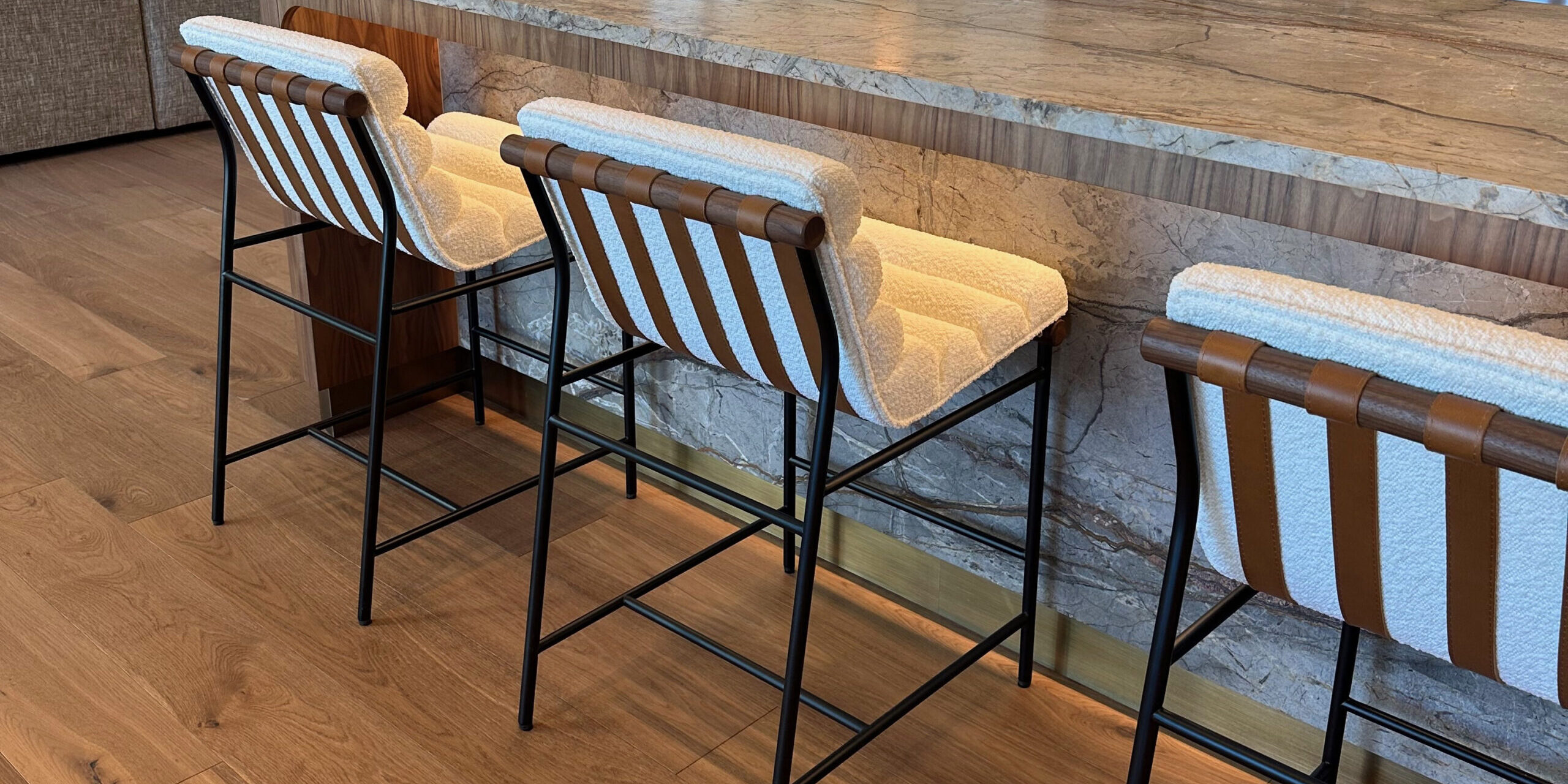 A metallic kickplate set at the bottom of the kitchen island.