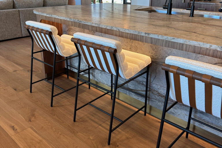 A metallic kickplate set at the bottom of the kitchen island.